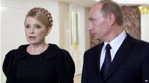 Sunday, Jan. 18, 2009 file photo Vladimir Putin, right, looks at his Ukrainian leader Yulia Tymoshenko